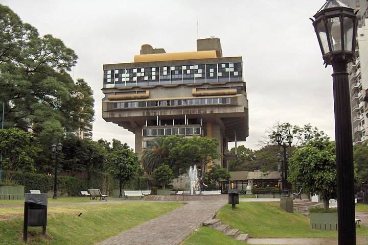 a small clock tower in the middle of a park